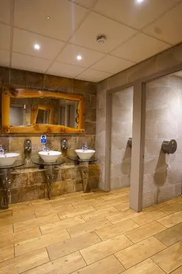 a bathroom with three sinks in a room at Hardgate House Hotel in Clydebank