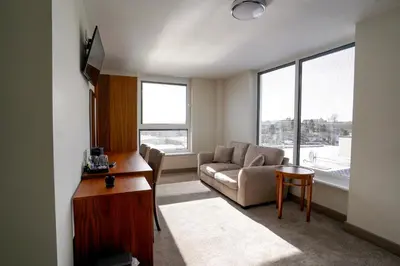 a living room with a couch and a table at Hardgate House Hotel in Clydebank