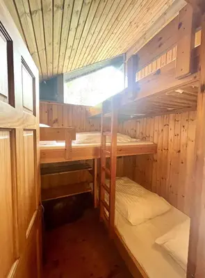 a wooden cabin with two bunk beds in it at Seil Log Cabin in Dalavich