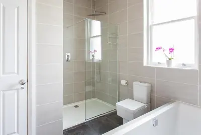 a white bathroom with a shower and a toilet at Large and luxurious country home near Glasgow in Eaglesham