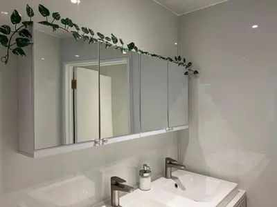 a bathroom with a sink and a mirror at Spacious boutique two-bedroom apartment next to the castle in Edinburgh