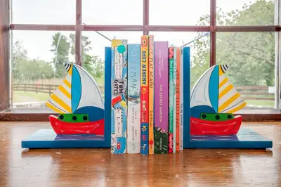 a group of books sitting on a table at Courtyard Cottages Rose Cottage in Wigtown
