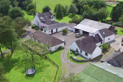 an aerial view of a large house with a yard at Courtyard Cottages Rose Cottage in Wigtown