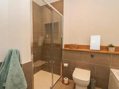 a bathroom with a toilet and a glass shower at Kalipé in Aberfeldy