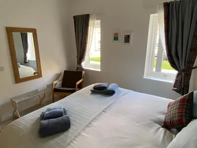 a bedroom with a bed with two towels on it at Kalipé in Aberfeldy