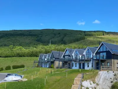 a row of houses in the middle of a field at Kalipé in Aberfeldy