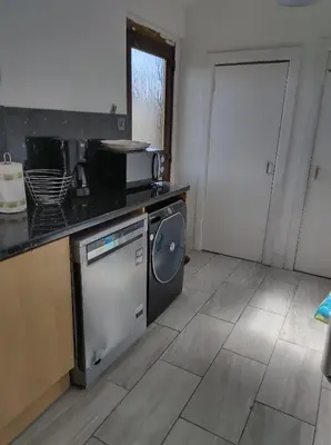 a kitchen with a sink and a dishwasher at Kumba in Kilmarnock