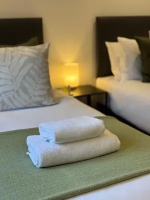 a pile of towels sitting on top of a bed at The Gîte in the Highlands in Acharra