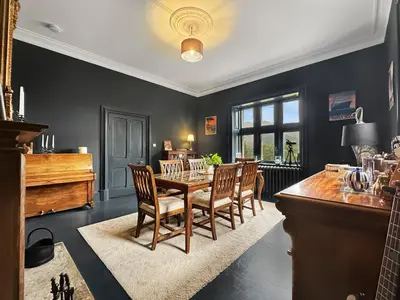 a dining room with a table and chairs at St John's Old Rectory in Glencoe