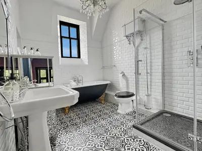 a bathroom with a tub and a sink and a toilet at St John's Old Rectory in Glencoe