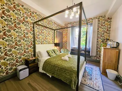 a bedroom with a bed and floral wallpaper at River Haven Edinburgh in Edinburgh