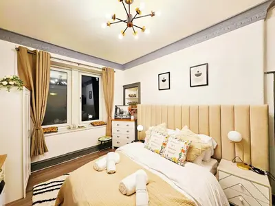 a bedroom with a large bed and a window at River Haven Edinburgh in Edinburgh