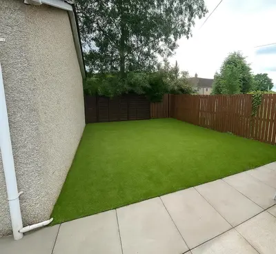 a garden with green grass next to a fence at Register House Family or Contractor 4bed with Garden Driveway in Bellshill