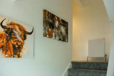 a painting of a bull hanging on a wall at Register House Family or Contractor 4bed with Garden Driveway in Bellshill