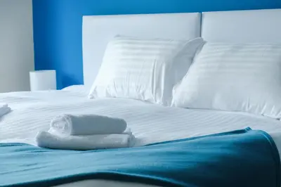 a bed with white sheets and towels on it at Register House Family or Contractor 4bed with Garden Driveway in Bellshill
