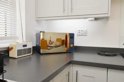 a microwave sitting on a counter in a kitchen at Kilin in Lochgilphead