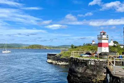a lighthouse on the side of a body of water at Kilin in Lochgilphead