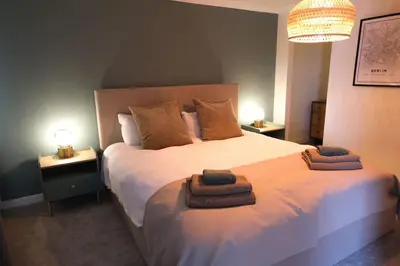 a bedroom with a large bed with two towels on it at Lang Toon House - 3 bedrooms in Auchterarder