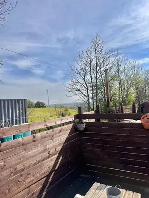 a wooden fence with a pool of water at Swift 3-Bedroom Caravan Located in Uddingston, Glasgow at Maryville Caravan Site in Uddingston