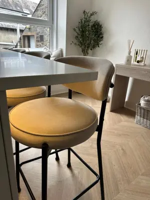 a dining room with a table and a chair at Luxury High Street Apartment in Moffat