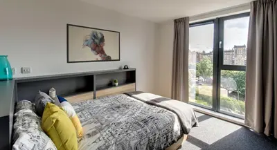a bedroom with a bed with a horse picture on the wall at Abodus St James Glasgow in Glasgow