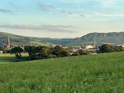 a green field with a town in the distance at Peel House Bed and Breakfast in Girvan