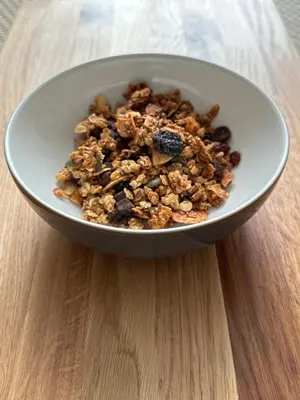 a bowl of granola on a wooden table at Peel House Bed and Breakfast in Girvan