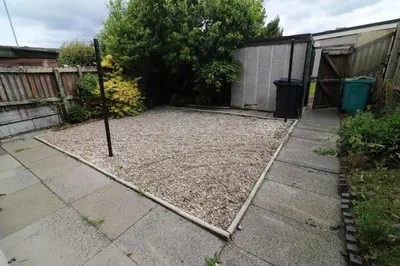 a yard with a fence and a sidewalk at Signature - Martin House in Old Monkland