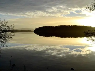 a view of a lake at sunset at Tarandoun Cottage in Helensburgh