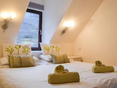 a bedroom with two teddy bears on a bed at Pine Marten Cottage in Ballachulish