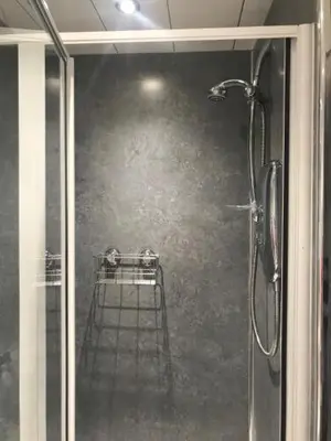 a shower with a glass door in a bathroom at Daviot Guest House in Ayr
