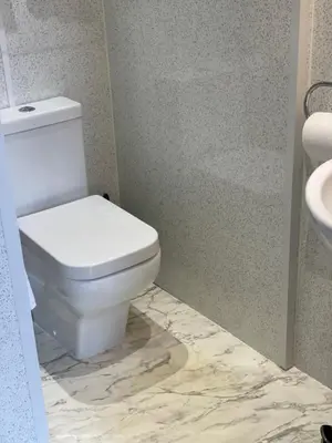 a bathroom with a white toilet and a sink at Daviot Guest House in Ayr