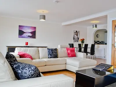 a living room with a couch and a table at Seaview in Oban