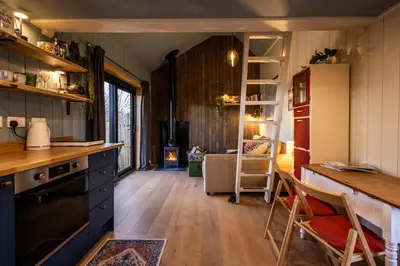 a kitchen with a counter and a table in a room at Jura - The Rusty Hut in Craighouse