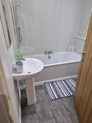 a bathroom with a sink and a bath tub at Ardenslate House in Kirn