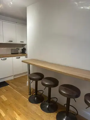 a kitchen with a table and four stools at Edinburgh Lauriston 4 bedroom 7 beds duplex in Edinburgh