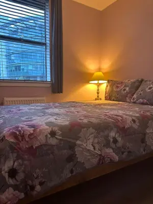 a bedroom with a bed with a lamp and a window at Edinburgh Lauriston 4 bedroom 7 beds duplex in Edinburgh