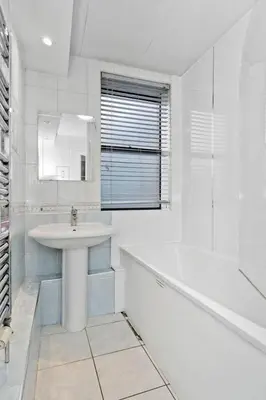 a white bathroom with a sink and a tub at Edinburgh Lauriston 4 bedroom 7 beds duplex in Edinburgh