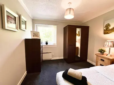 a bedroom with a bed and a window at Spacious 2 Bed-Flat in Glasgow City - Free Parking in Glasgow