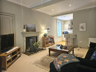 a living room with a couch and a fireplace at Edinburgh Elegant 1-Bedroom City Apartment in Edinburgh