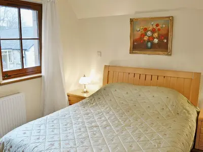a bedroom with a bed and a window at The Wheelhouse in Linlithgow