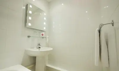 a white bathroom with a sink and a toilet at Normandy Hotel (Near Glasgow Airport) in Paisley