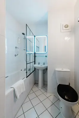 a bathroom with a toilet and a sink and a shower at Normandy Hotel (Near Glasgow Airport) in Paisley