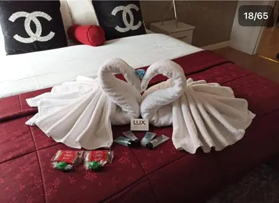 two swansrendered to look like they are kissing on a bed at HLA king court 3 in Motherwell