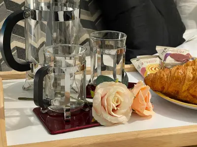 a coffee maker sitting on a table with a flower at HLA king court 3 in Motherwell