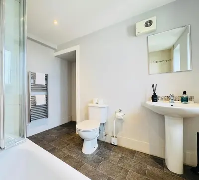 a bathroom with a toilet and a sink and a shower at Skyline View Apartment in Edinburgh