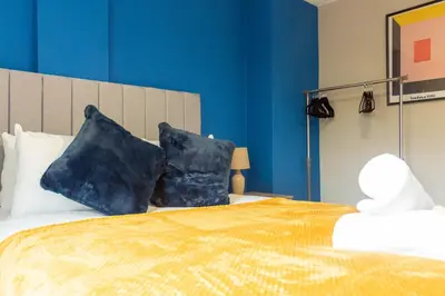 a bedroom with a bed with two pillows on it at Campsie View in Glasgow