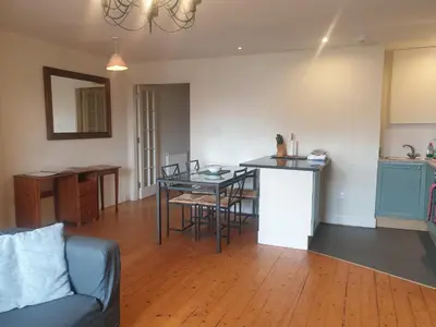 a living room with a table and a kitchen at Rose Street 2 bedroom in Edinburgh