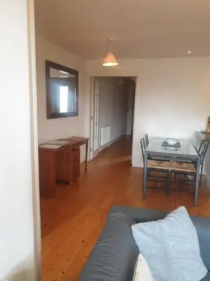 a living room with a blue couch and a table at Rose Street 2 bedroom in Edinburgh