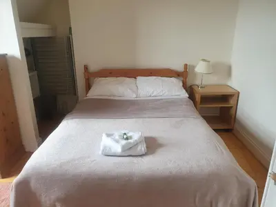 a bed with a white towel on top of it at Rose Street 2 bedroom in Edinburgh